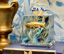 Load image into Gallery viewer, Decorative match holder with fish design on a blue surface, branded 'Southern Tribute'.
