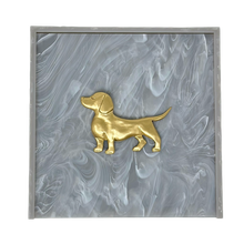 Load image into Gallery viewer, Gold dog figurine on a gray marbled background