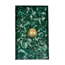 Load image into Gallery viewer, Green textured book with a gold circular object on a white background