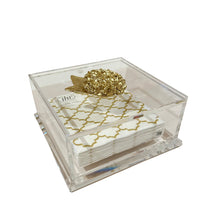 Load image into Gallery viewer, Clear acrylic box with gold decorative element containing white cards on a white background