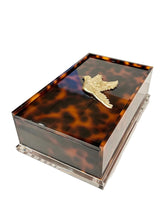 Load image into Gallery viewer, Tortoiseshell-patterned jewelry box with a gold bird emblem on a white background