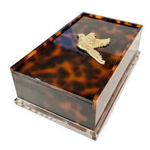 Load image into Gallery viewer, Tortoiseshell-patterned jewelry box with a gold bird emblem on a white background