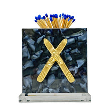 Load image into Gallery viewer, Matches with blue tips in a decorative holder with a gold 'X' on a white background