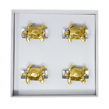 Load image into Gallery viewer, Set of gold turtle-shaped napkin rings in a box on a white background