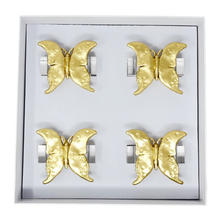 Load image into Gallery viewer, Set of four gold butterfly-shaped napkin rings in a box on a white background