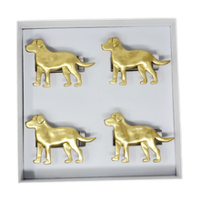 Load image into Gallery viewer, Set of four gold dog-shaped napkin rings in a box on a white background