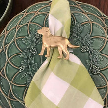 Load image into Gallery viewer, Gold dog-shaped napkin holder on a green and white checkered napkin against a decorative green plate.