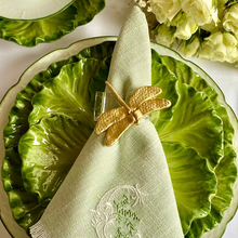Load image into Gallery viewer, Green ceramic plate with a napkin featuring a dragonfly design, surrounded by silverware and flowers on a white tablecloth.
