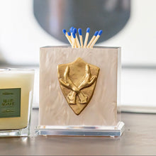 Load image into Gallery viewer, Candle and decorative container with a coat of arms on a table
