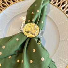 Load image into Gallery viewer, Green polka dot napkin with a gold napkin ring on a white plate with gold rim.
