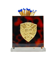 Load image into Gallery viewer, Matches in a holder with a gold emblem on a tortoiseshell-patterned background
