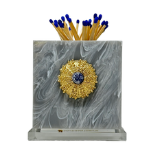 Load image into Gallery viewer, Match holder with a sea urchin design on a gray marbled background
