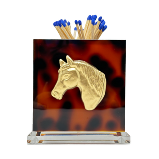 Matchbox holder with gold horse head design on a tortoiseshell patterned base.
