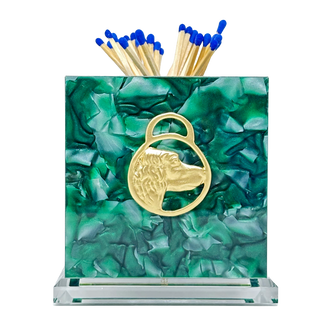 Green marble matchbox with gold matches on a white background