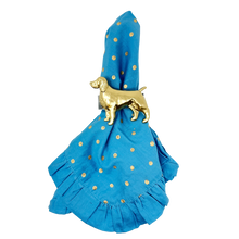 Load image into Gallery viewer, Blue napkin with gold polka dots and a gold dog-shaped napkin ring on a white background

