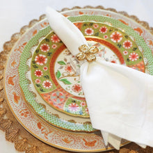 Load image into Gallery viewer, Decorative plate with floral pattern and white napkin on a gold doily
