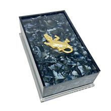 Load image into Gallery viewer, Marbled patterned box with a gold emblem on a white background
