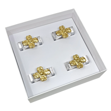 Load image into Gallery viewer, Set of gold flower-shaped napkin rings in a white box on a white background
