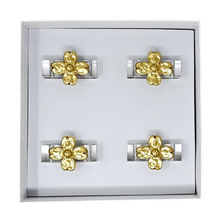Load image into Gallery viewer, Set of gold flower napkin rings on a white background
