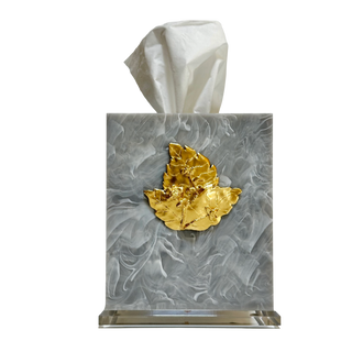 Tissue box cover with marble design and gold leaf on a white background