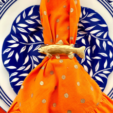 Load image into Gallery viewer, Orange fabric with gold patterns on a blue and white decorative plate
