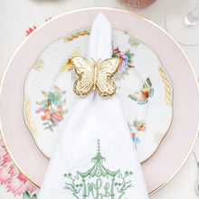 Load image into Gallery viewer, Decorative table setting with a white napkin featuring green text, gold butterfly, and floral plate.
