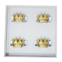 Load image into Gallery viewer, Set of four gold crown-shaped napkin rings in a display box on a white background
