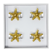 Load image into Gallery viewer, Gold starfish napkin rings on a white card with a clear base
