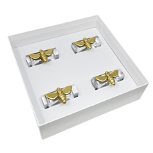 Load image into Gallery viewer, Set of gold bee napkin rings in a white box on a white background

