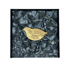 Load image into Gallery viewer, Gold bird-shaped object on a textured black and gray background
